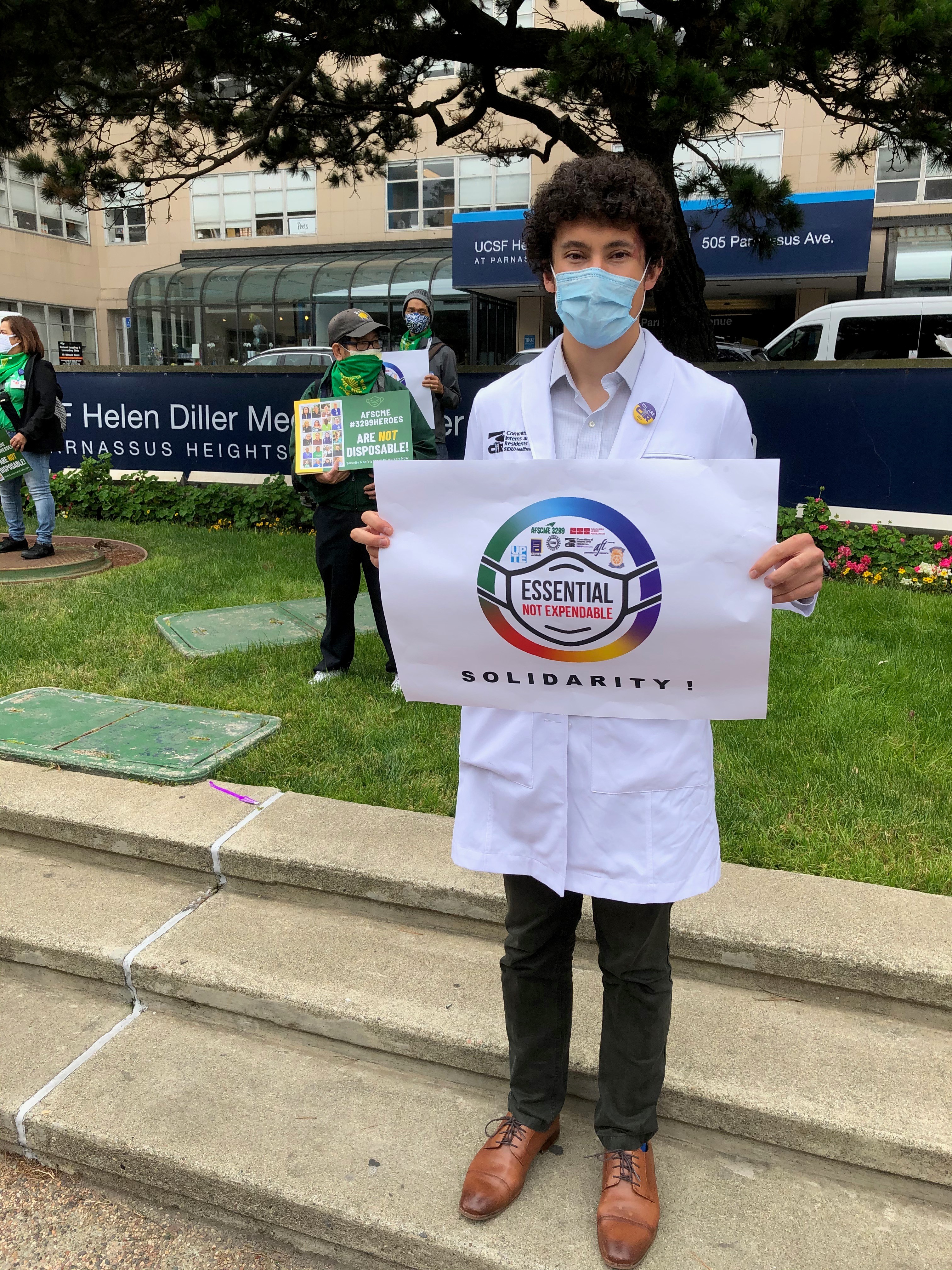 Andreas Mitchell holding sign at Healthcare worker Rights Rally